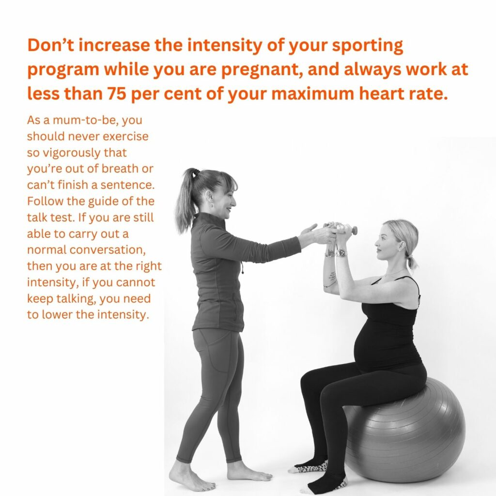Pregnant woman exercising on the Pilates fit ball being guided by an instructor
